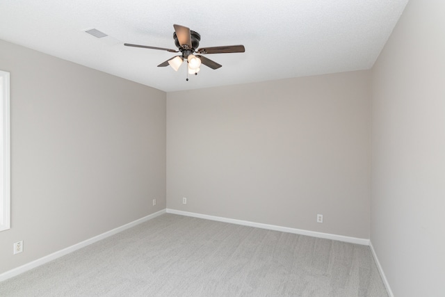 unfurnished room with light carpet, a textured ceiling, and ceiling fan