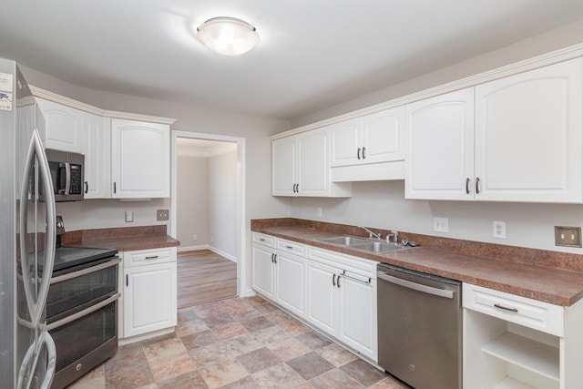 kitchen with white cabinetry, appliances with stainless steel finishes, and sink