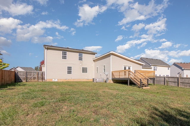 rear view of property featuring a yard