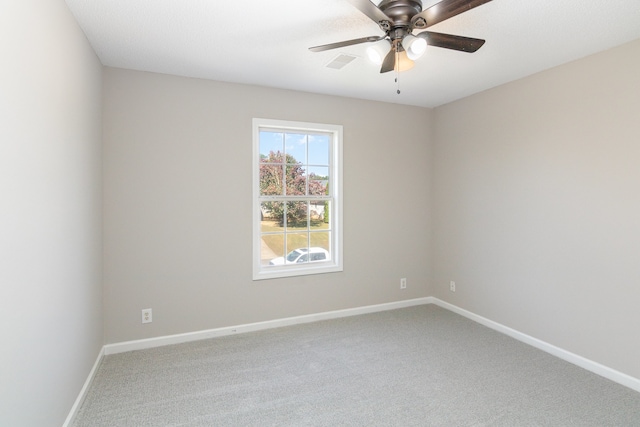 carpeted empty room featuring ceiling fan