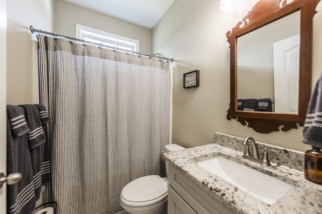 bathroom with toilet, vanity, and a shower with shower curtain