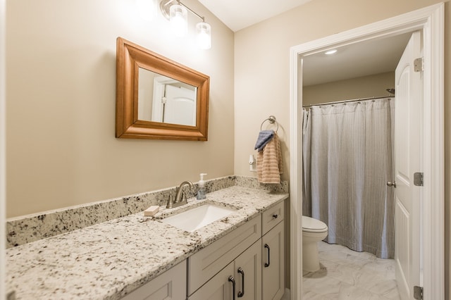 bathroom featuring toilet, vanity, and a shower with shower curtain