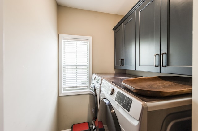 laundry area with cabinets and washing machine and clothes dryer