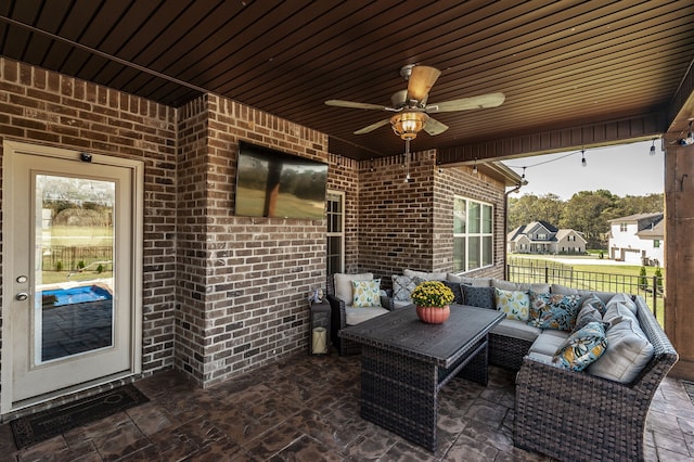 view of patio with an outdoor living space and ceiling fan