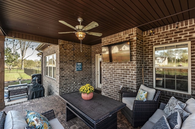 view of patio with ceiling fan, a grill, and an outdoor living space