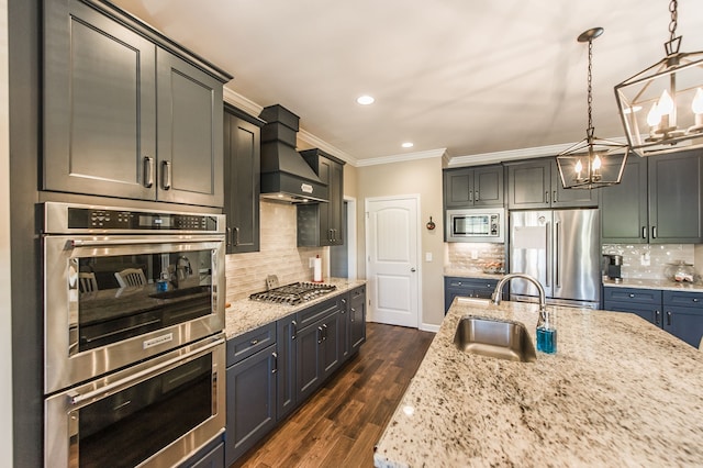 kitchen featuring dark wood-type flooring, hanging light fixtures, sink, custom exhaust hood, and appliances with stainless steel finishes