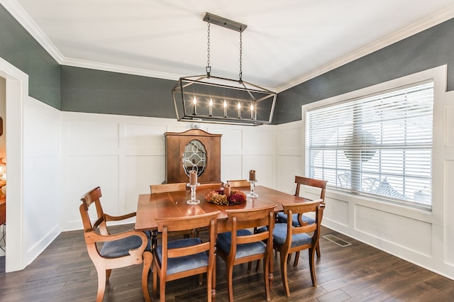 dining space featuring crown molding and dark hardwood / wood-style floors