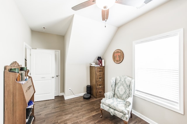 living area featuring dark wood-type flooring, ceiling fan, vaulted ceiling, and plenty of natural light