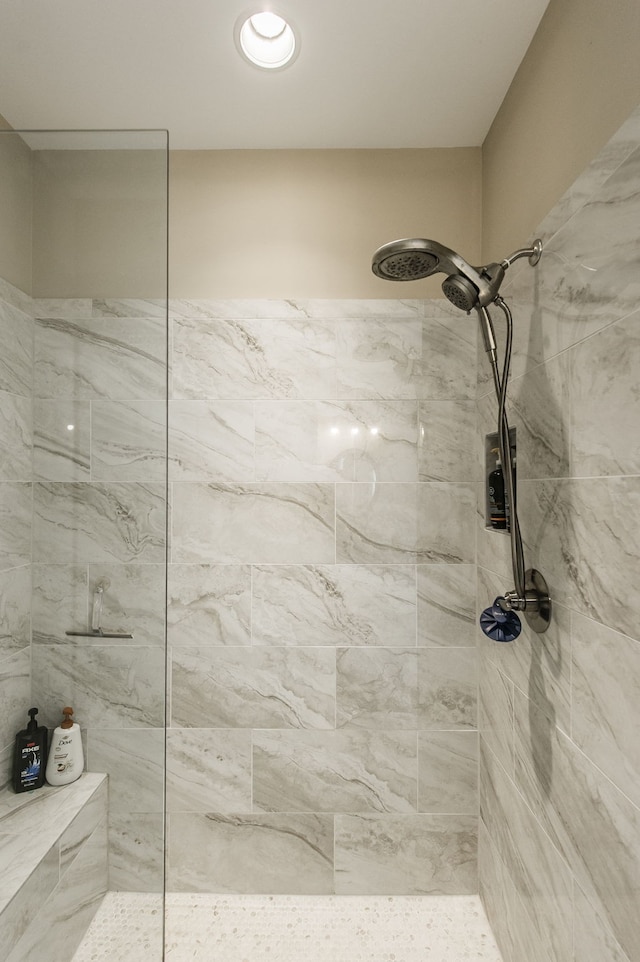 bathroom with tiled shower