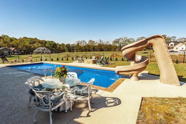 view of swimming pool featuring a yard and a patio