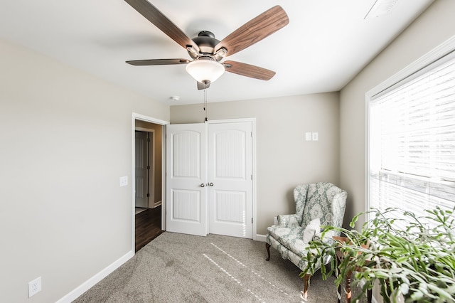 sitting room with ceiling fan and carpet floors