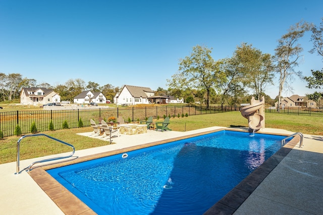 view of pool with a yard, a water slide, and a patio area