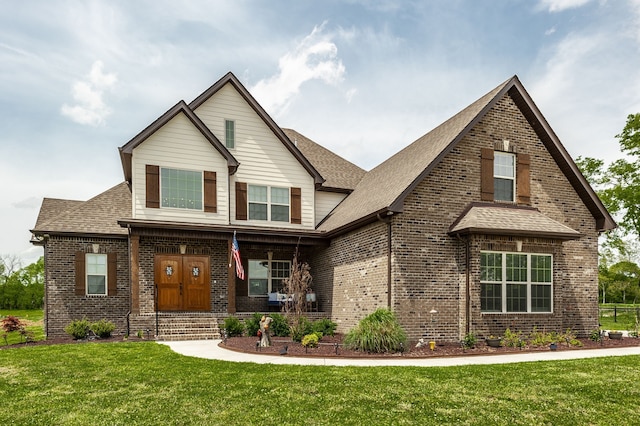 view of front facade with a front yard and covered porch