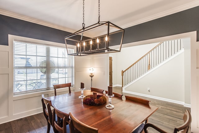 dining space with an inviting chandelier, crown molding, and dark hardwood / wood-style floors