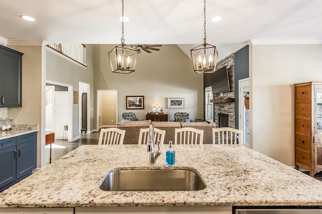 kitchen featuring ornamental molding, a breakfast bar, and hanging light fixtures