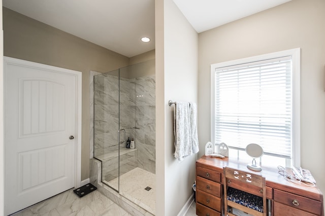 bathroom featuring a shower with shower door and a healthy amount of sunlight