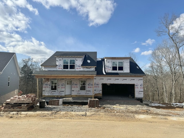 property in mid-construction featuring a garage, central air condition unit, and a porch