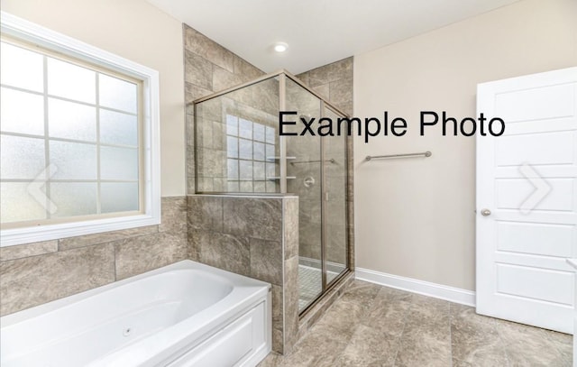 bathroom featuring shower with separate bathtub