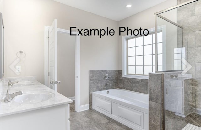 bathroom featuring vanity, independent shower and bath, and tile patterned flooring