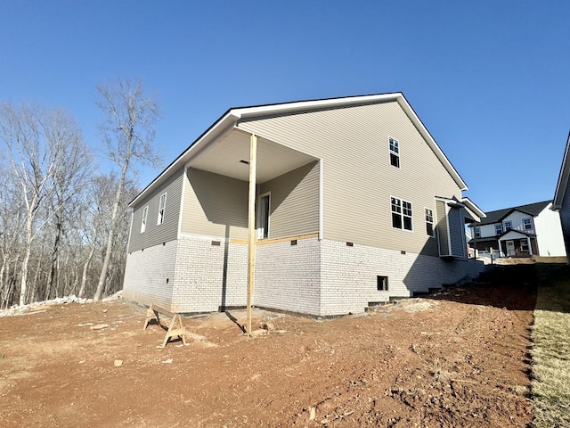 view of side of home with brick siding