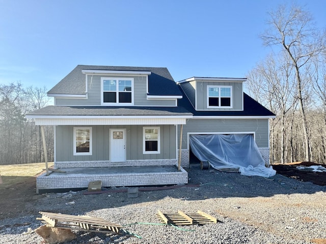 view of front facade with a porch and a garage