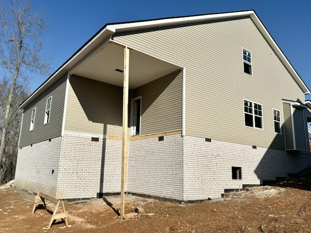 view of property exterior featuring brick siding