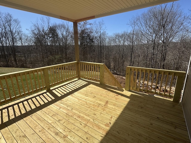 wooden deck with a forest view