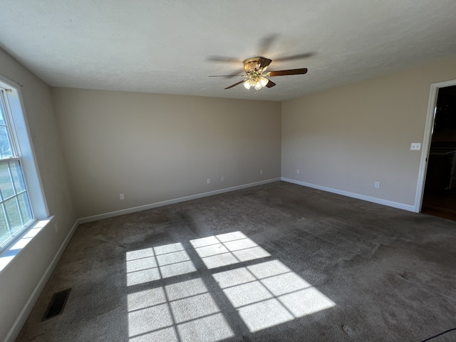 carpeted empty room featuring a textured ceiling and ceiling fan