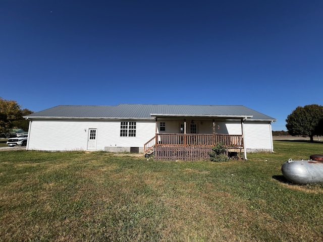 view of front of property featuring a front lawn and a deck