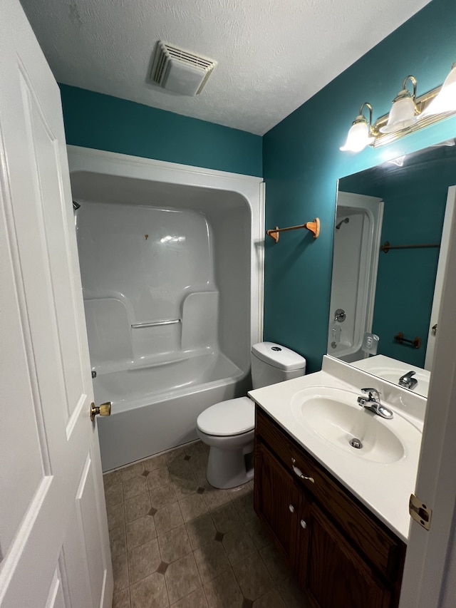 full bathroom featuring shower / bathing tub combination, vanity, a textured ceiling, and toilet