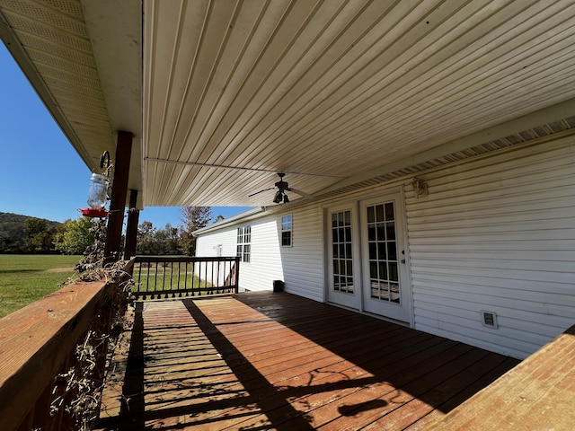 wooden terrace featuring ceiling fan