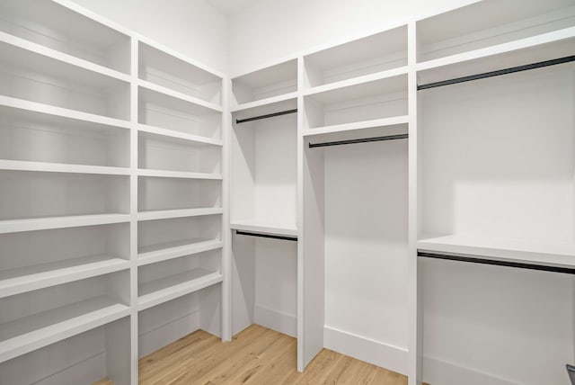 spacious closet with light hardwood / wood-style floors