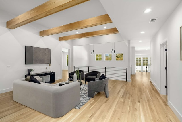 living room with light hardwood / wood-style floors and beam ceiling