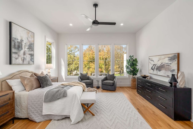 bedroom with light hardwood / wood-style floors and ceiling fan