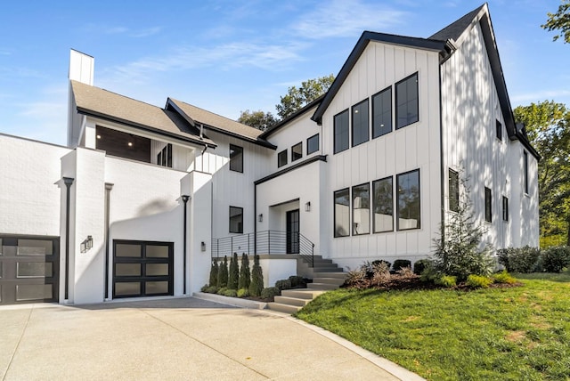 view of front of home with a front yard and a garage