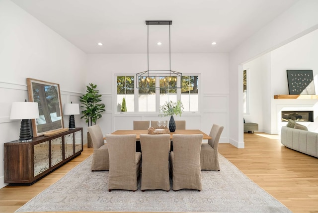 dining area featuring a notable chandelier and light wood-type flooring