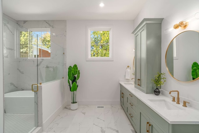 bathroom with vanity and shower with separate bathtub