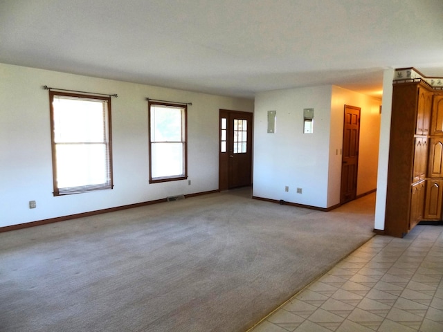 unfurnished room with light carpet and electric panel