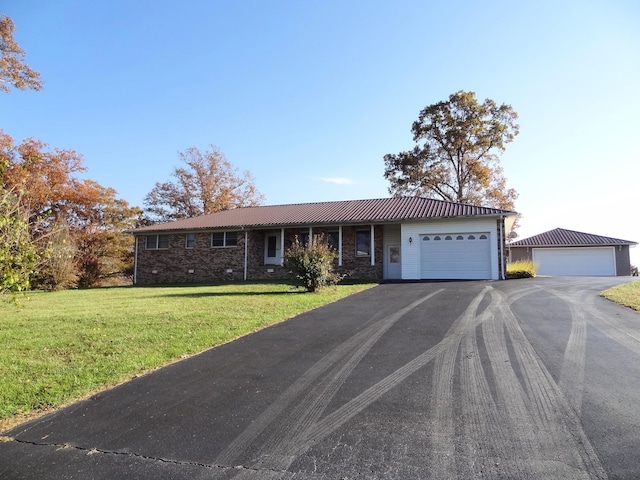 ranch-style house with a garage and a front lawn