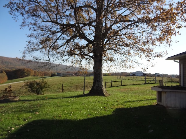 view of yard with a mountain view and a rural view