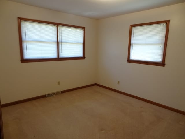 empty room featuring light colored carpet