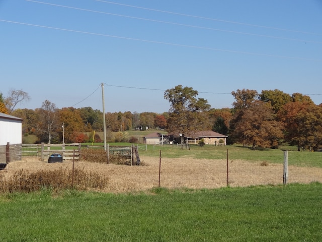 view of playground with a yard and a rural view