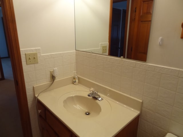 bathroom featuring tile walls and vanity