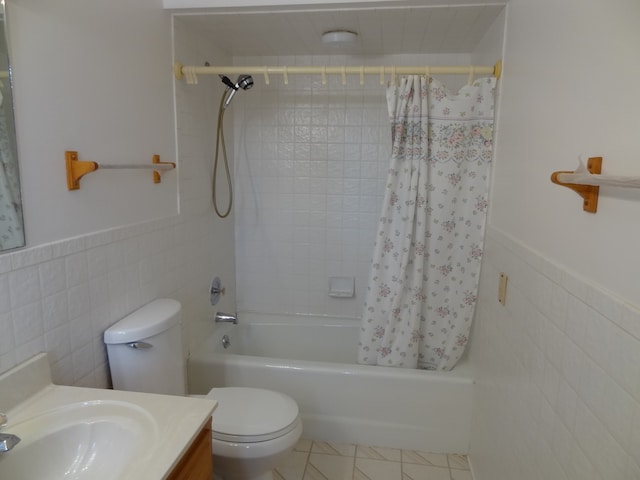 full bathroom with shower / bathtub combination with curtain, tile walls, toilet, vanity, and tile patterned floors