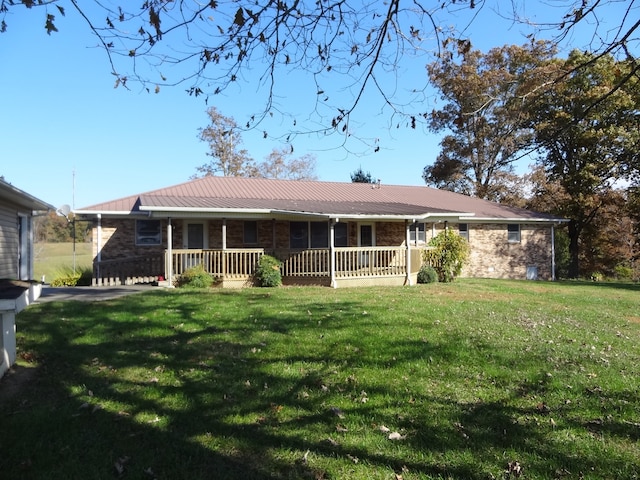 back of property featuring covered porch and a yard