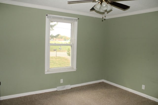 empty room with ornamental molding, carpet floors, plenty of natural light, and ceiling fan