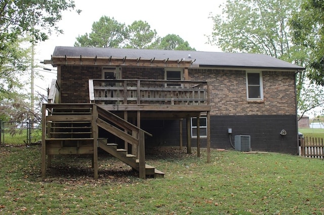 rear view of property featuring a wooden deck, cooling unit, and a yard