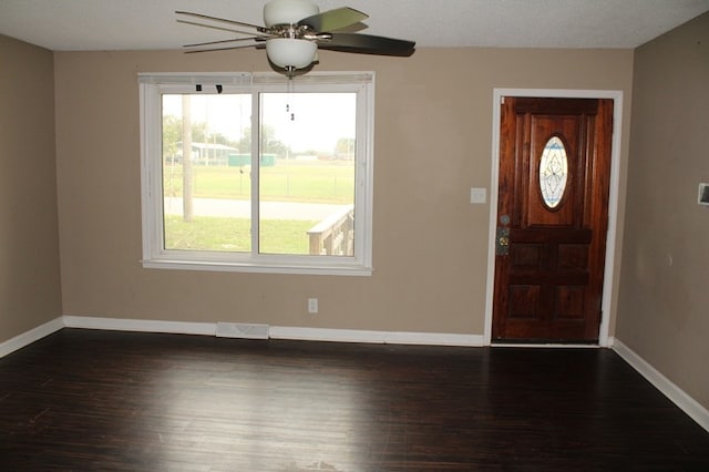 foyer entrance with ceiling fan, a textured ceiling, and dark hardwood / wood-style flooring