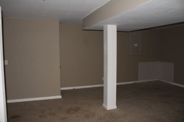 basement featuring dark carpet