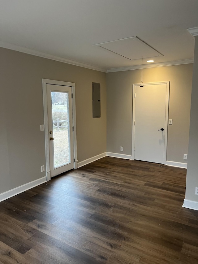 spare room with crown molding, dark hardwood / wood-style flooring, and electric panel